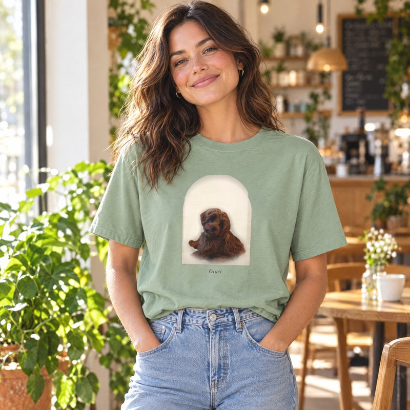 Lifestyle mockup: The Classic Tee worn at a café, with our sample portrait